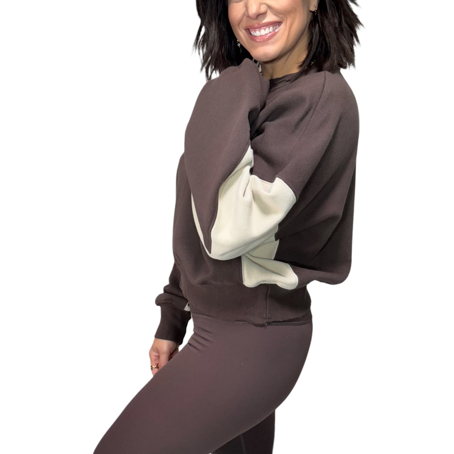 Side profile of a woman wearing a brown and white outfit on a white background