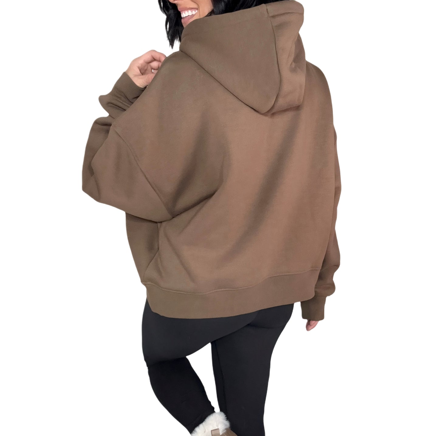 Back profile of a woman wearing a brown oversized hoodie on a white background