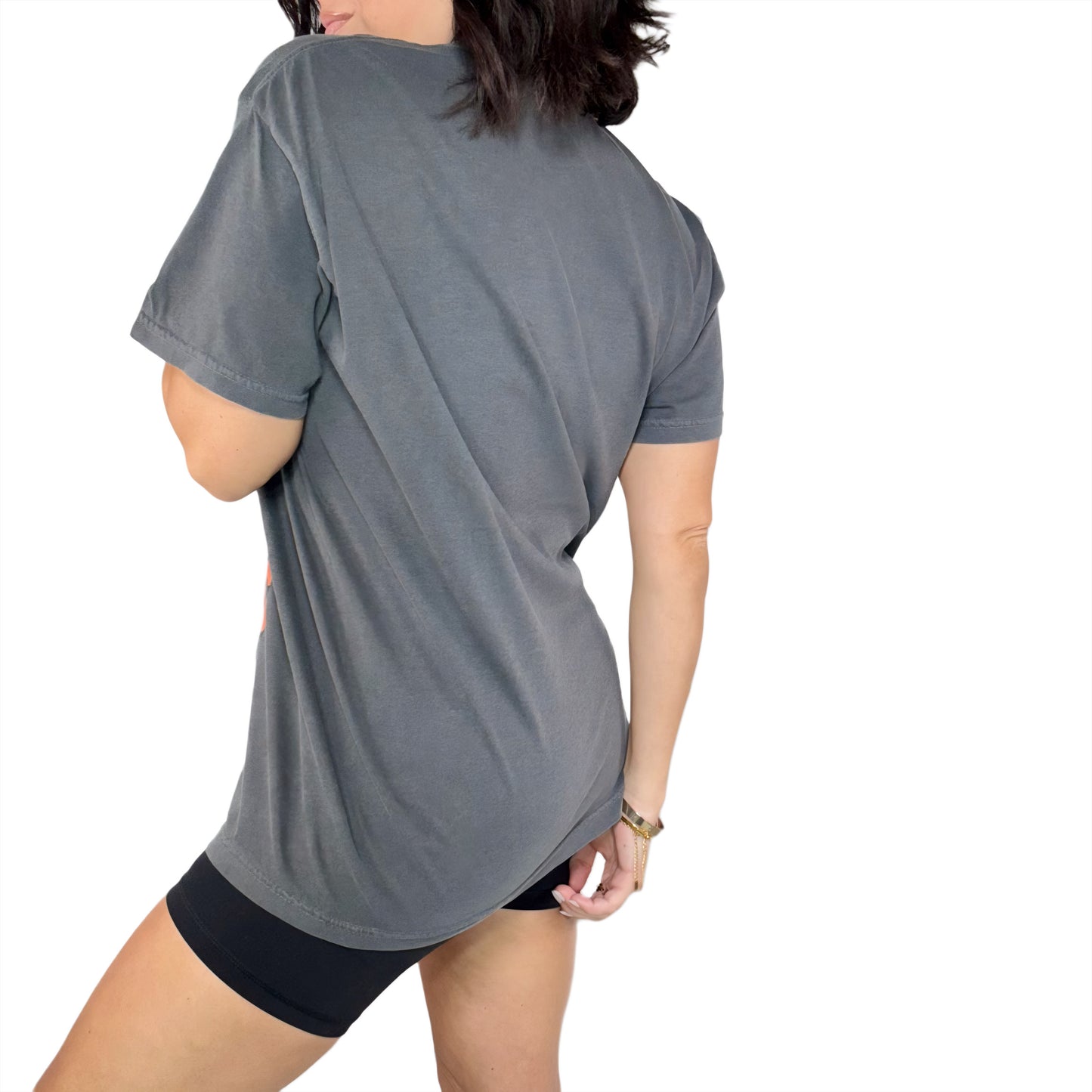 Woman wearing a gray t-shirt and black shorts on a white background
