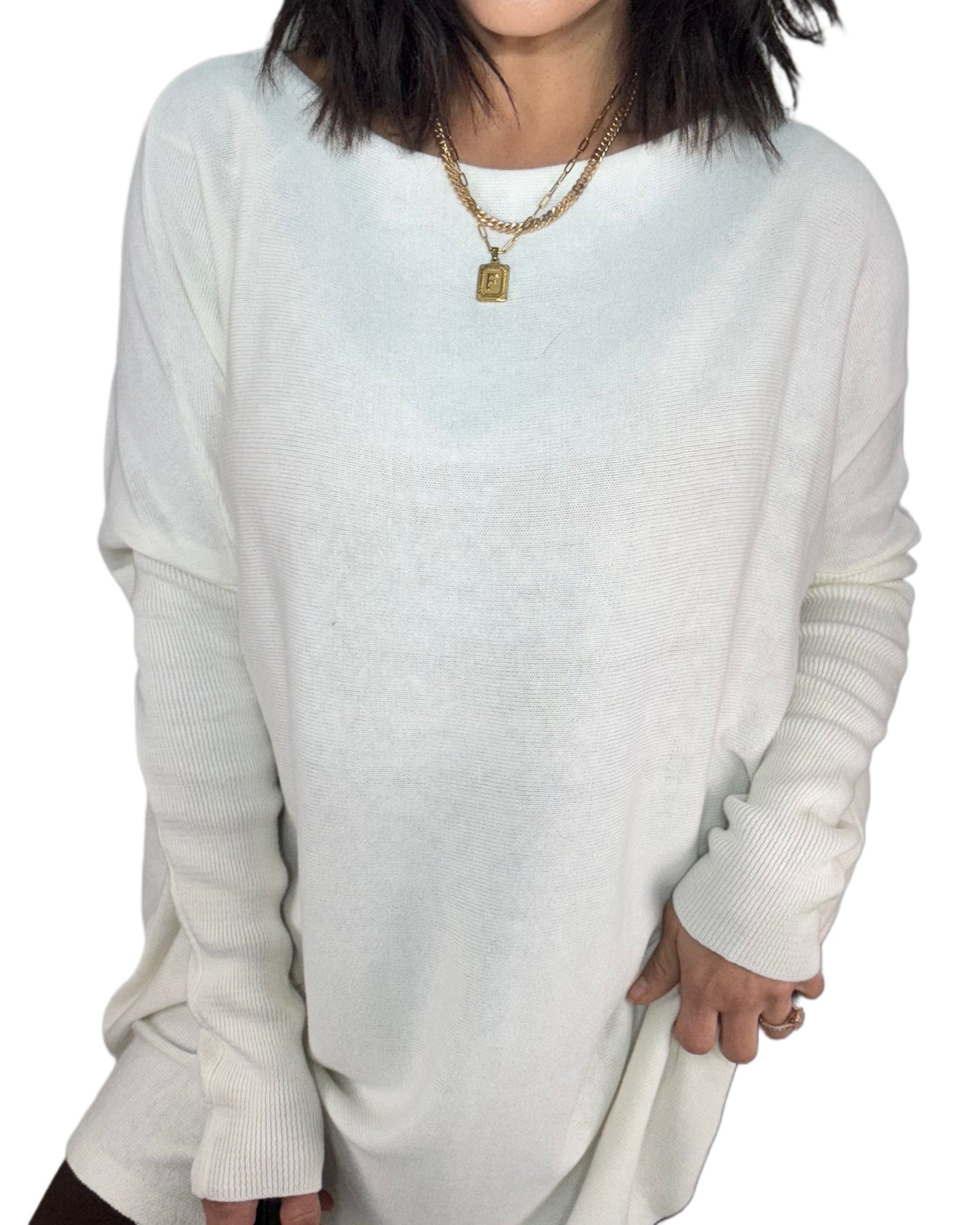 Close up of a woman wearing a white tunic top on a white background