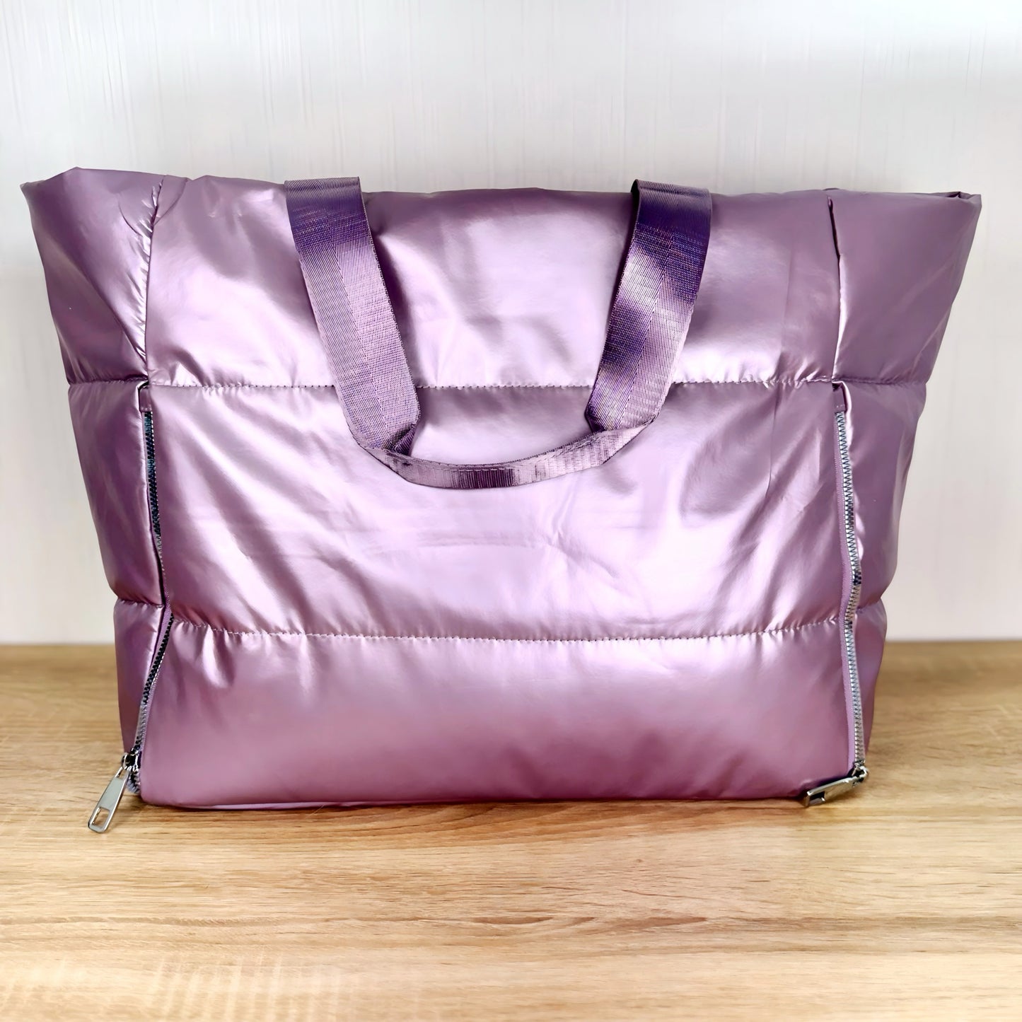 Lavender large travel tote bag on a light wooden table and a white background