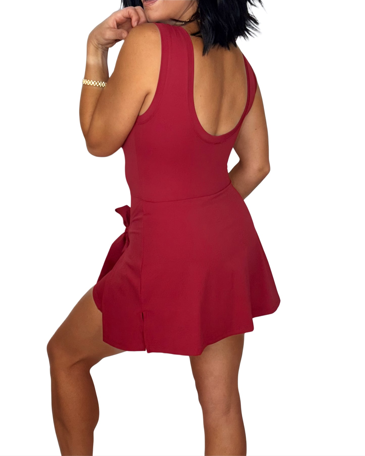 Back profile of a woman wearing a red romper on a white background