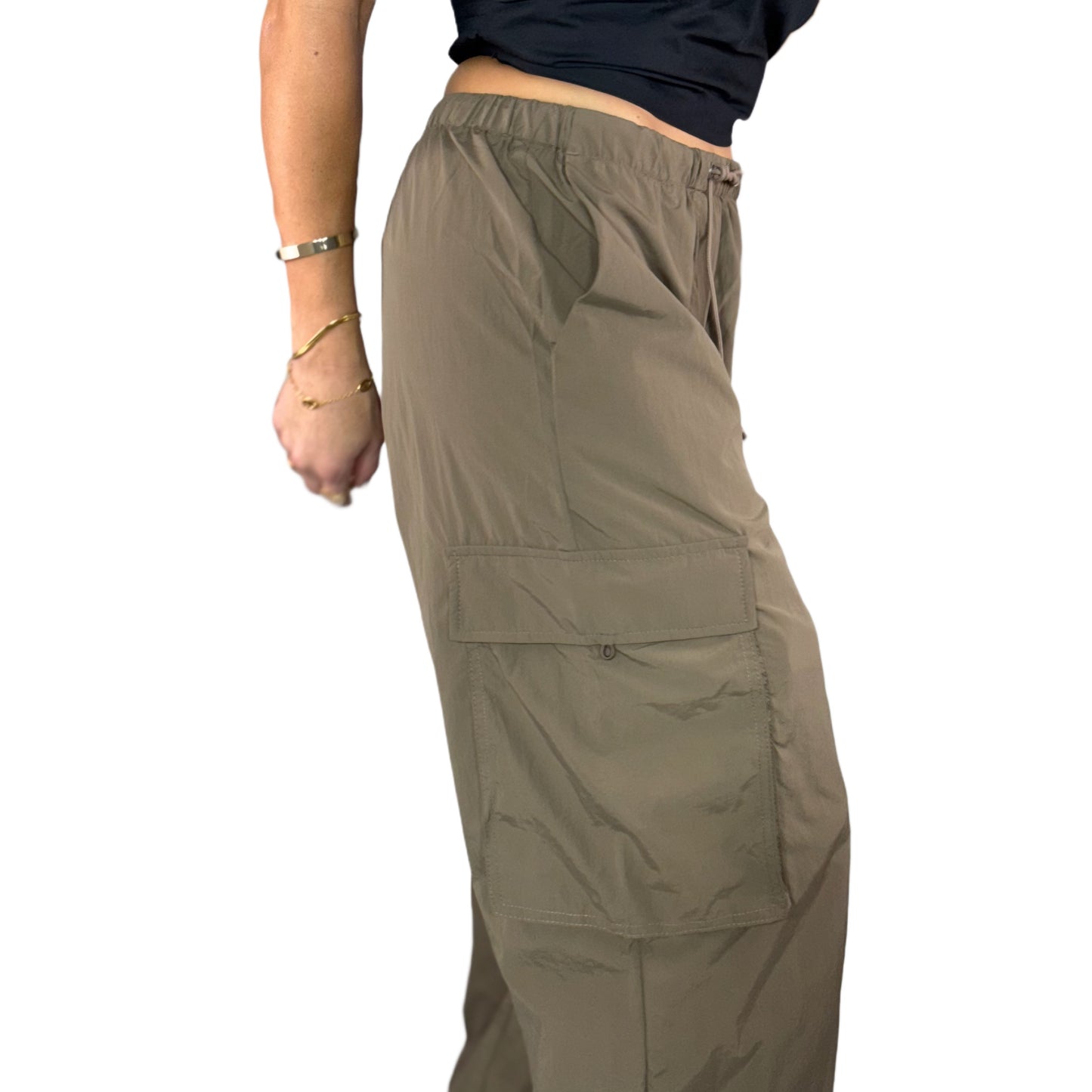 Side profile of brown cargo pants worn by a woman on a white background