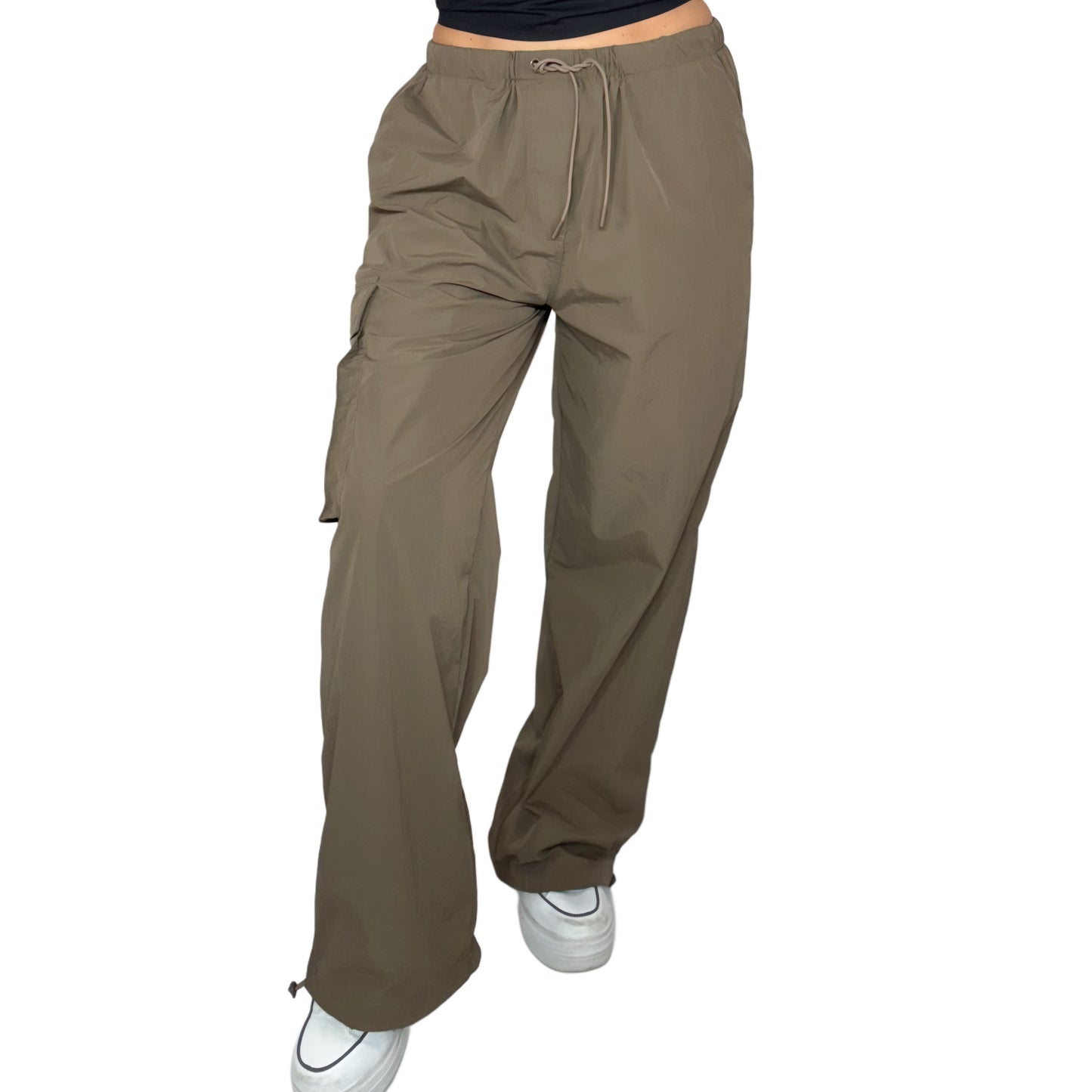 Close up of brown pants worn by a woman on a white background