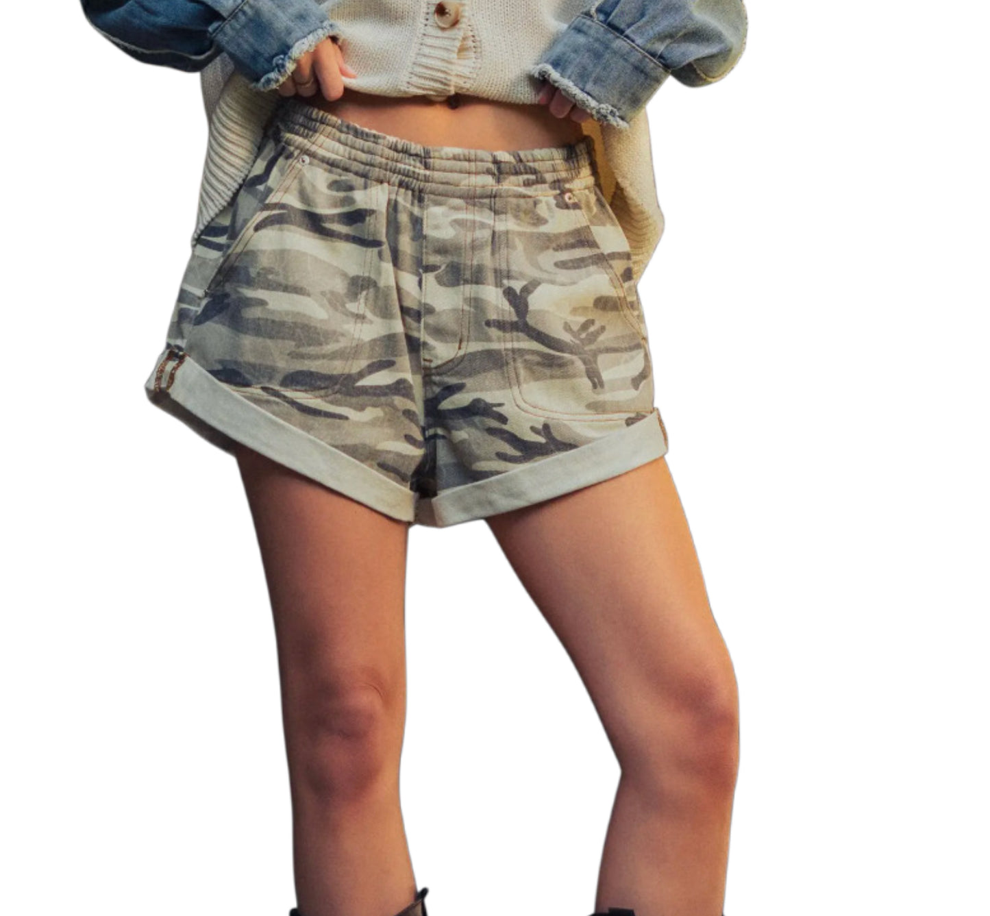 Woman wearing oversized camo shorts on a white background