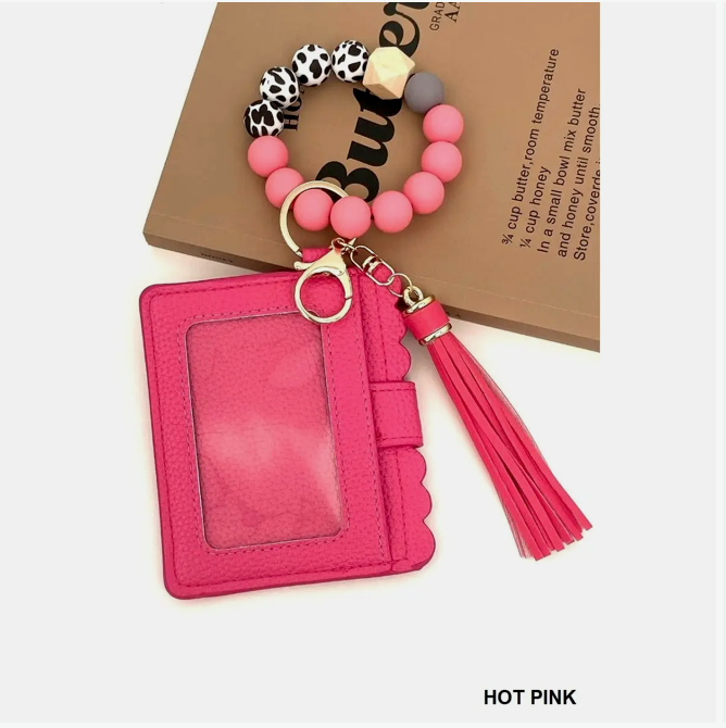 Hot pink cardholder with beaded keychain on a white background