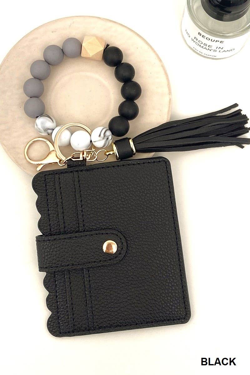 Black wallet with keychain and tassel on a white background