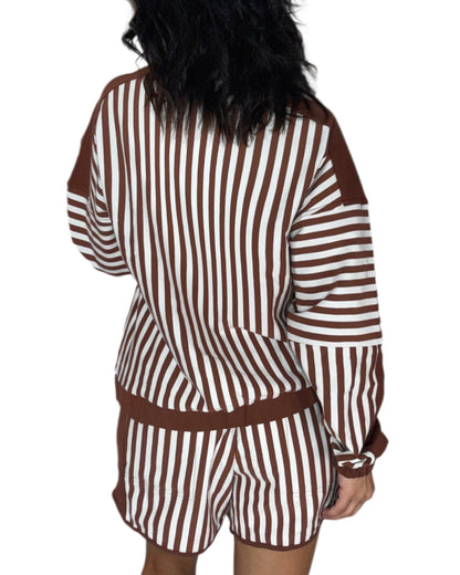 A person shown from the back wearing a brown and white vertically striped long-sleeve top and matching shorts against a plain white background.