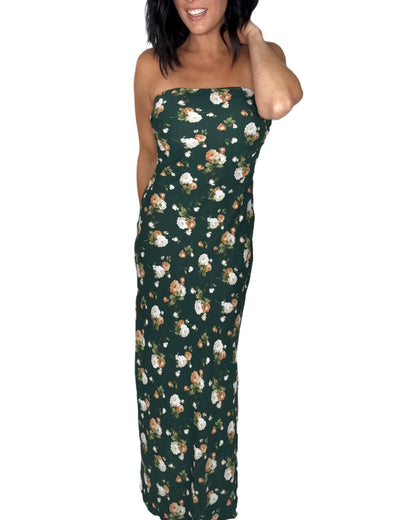Woman wearing a hunter green floral maxi dress on a white background 