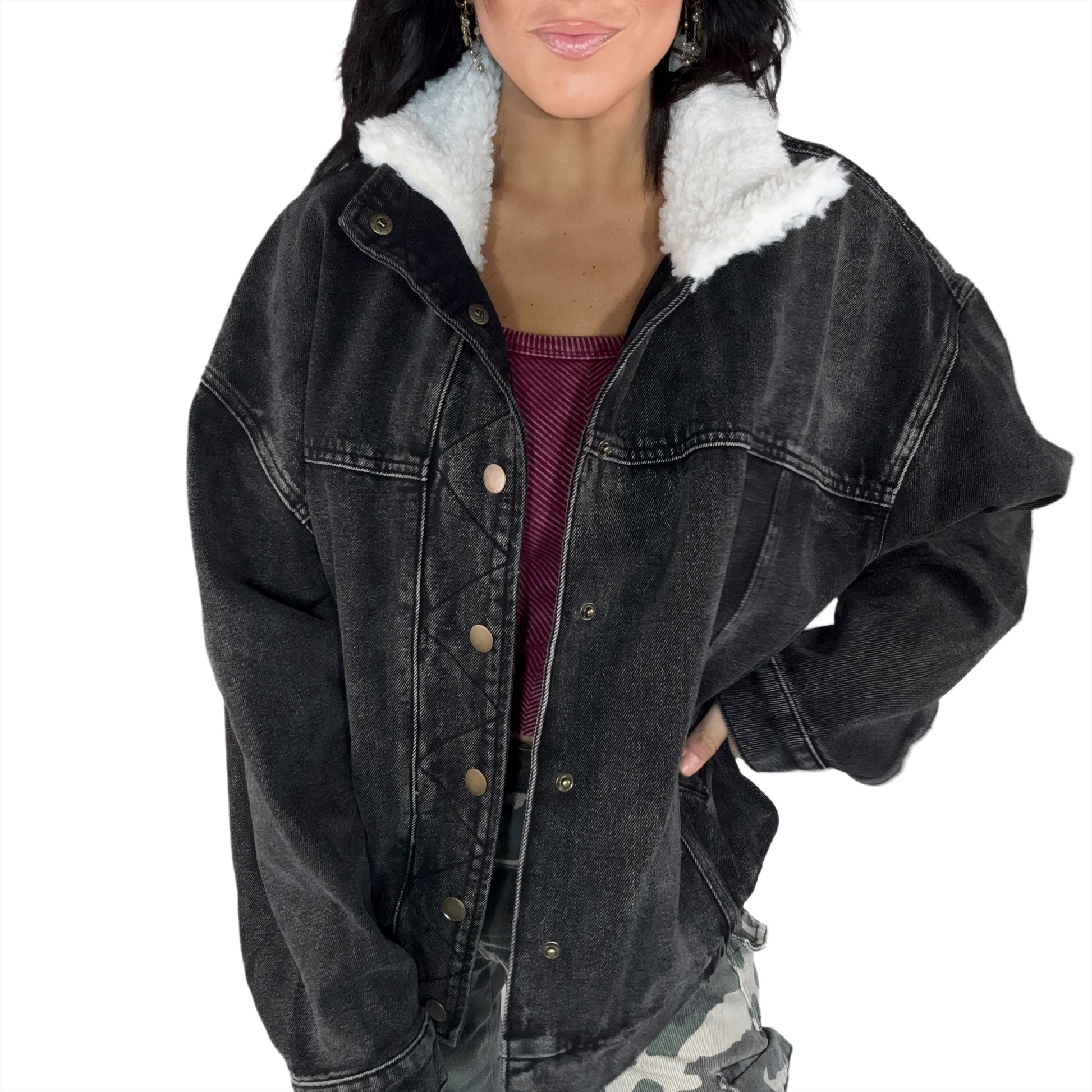 Black denim jacket with white fur lining worn by a woman on a white background