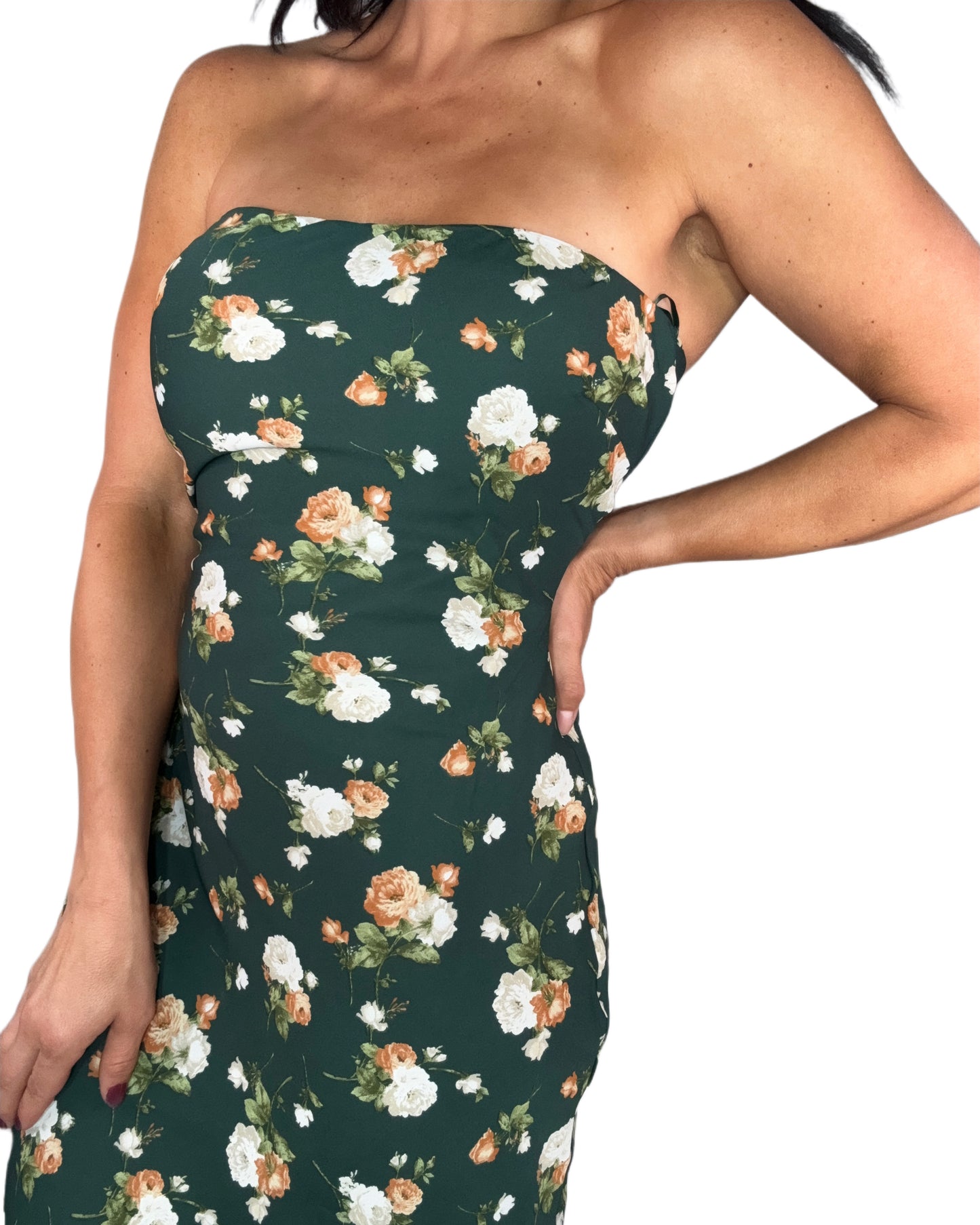 Close up of a woman wearing a hunter green floral maxi dress on a white background 