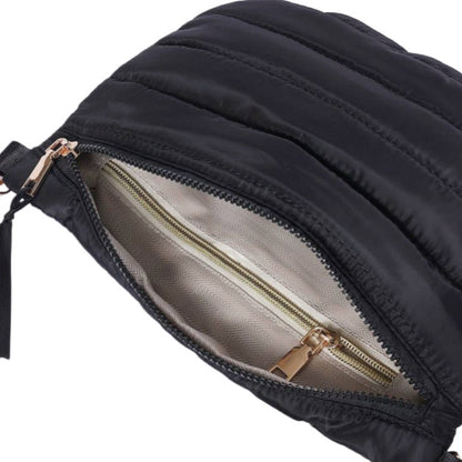 Black quilted bag with a gold zipper on a white background
