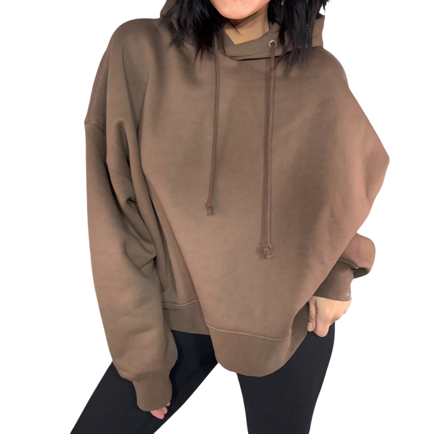 Woman wearing a brown oversized hoodie on a white background