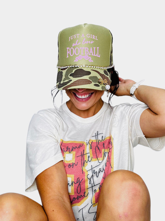 Woman wearing a snap backlit with a white tee and a white background
