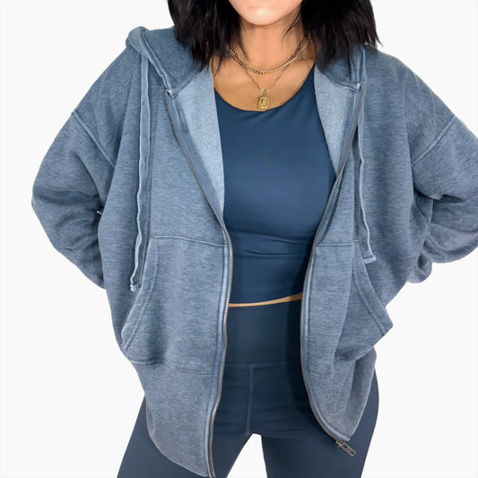 Woman wearing a Navy zip-up hoodie and matching navy outfit on a white background