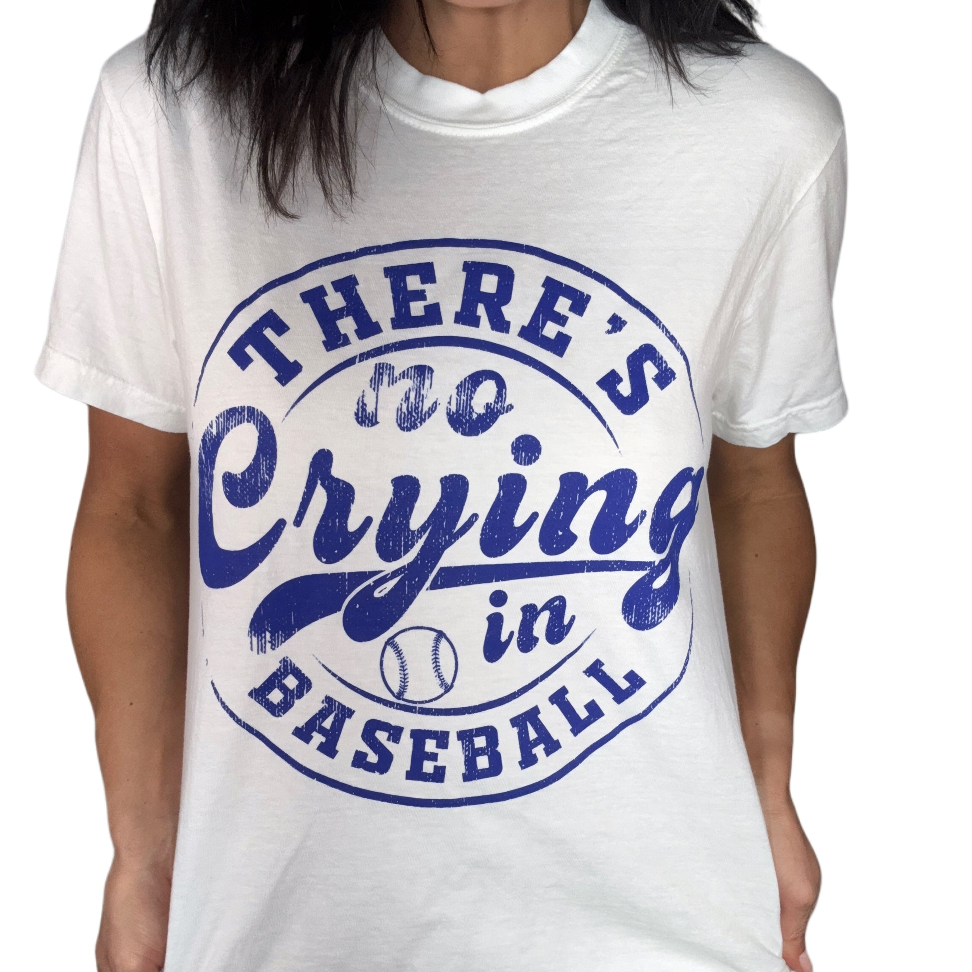 White t-shirt with blue text 'There's no crying in baseball' on a white background