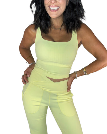 Close up of a woman wearing a ribbed active pant set on a white background