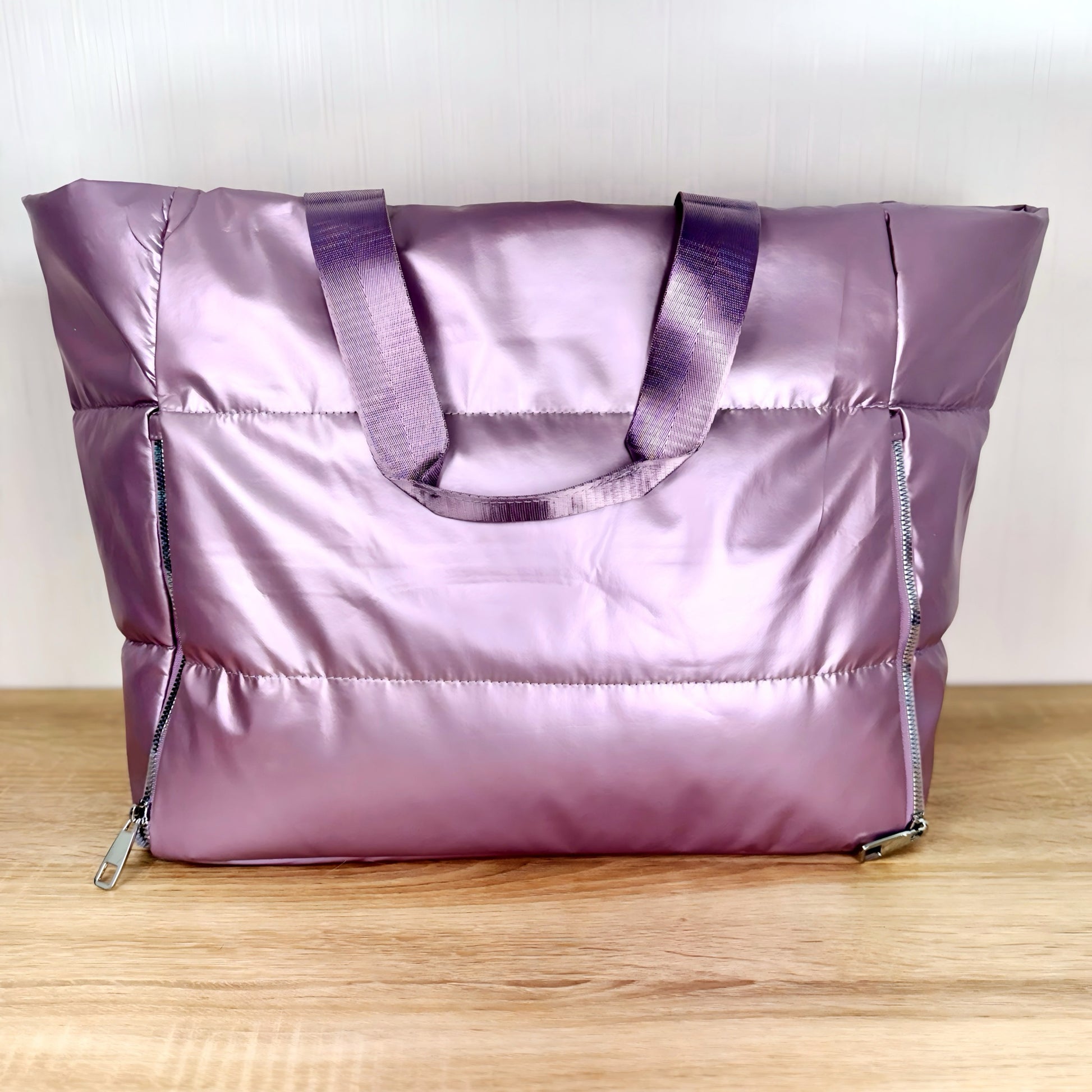 Lavender large travel tote bag on a light wooden table and a white background