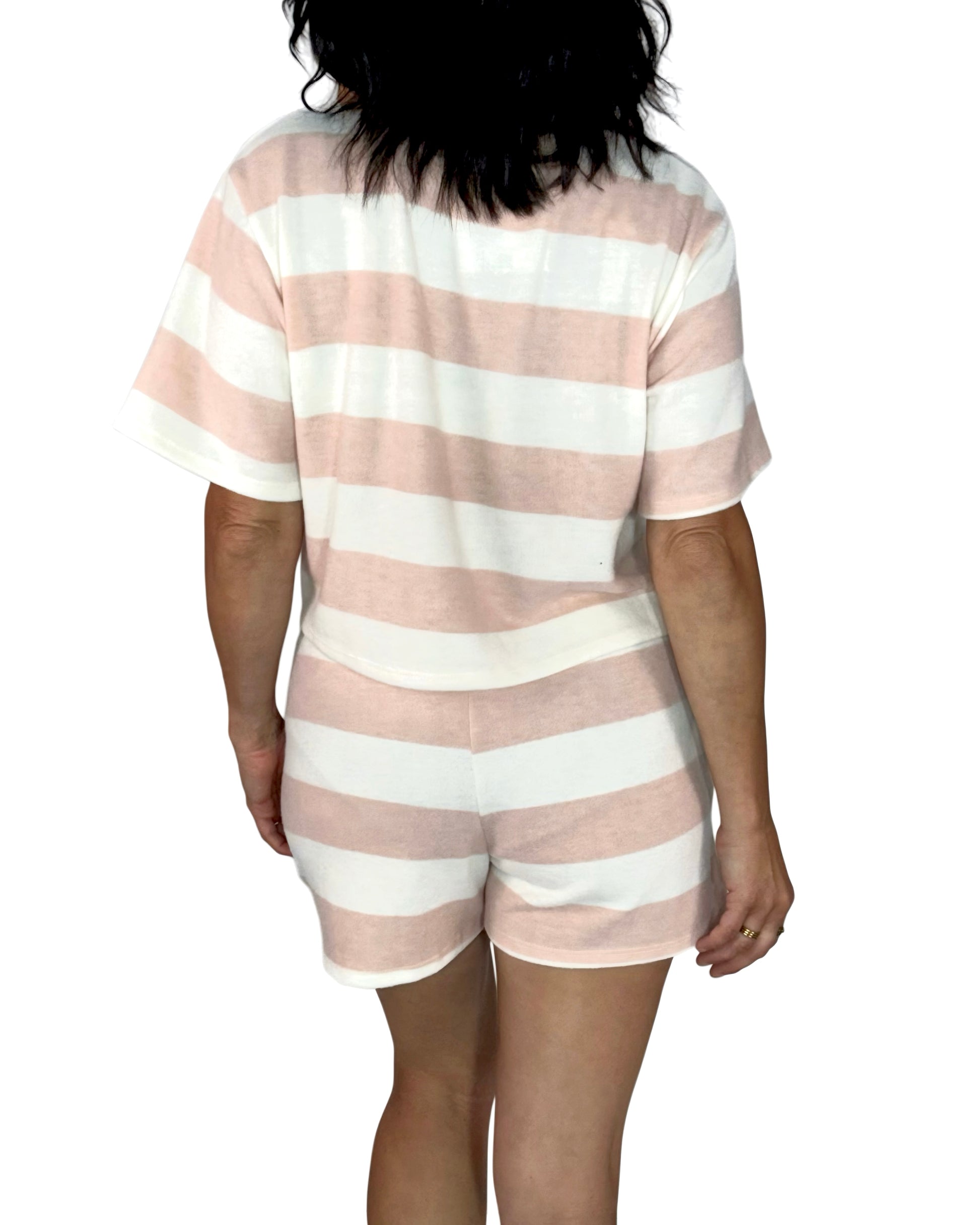 Back profile of a woman wearing a soft short set on a white background 