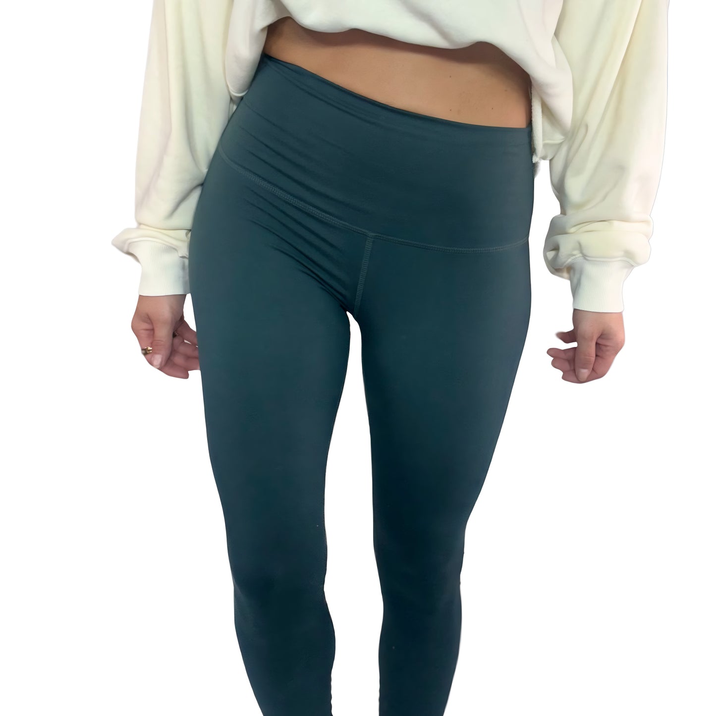 Woman wearing dark green  leggings and a off white sweatshirt on a white background
