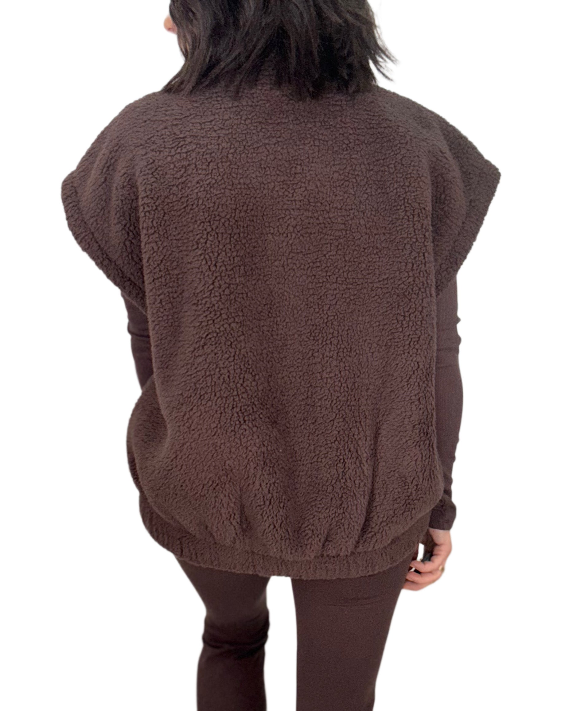 Back profile of a woman wearing a brown fleece vest  on a white background