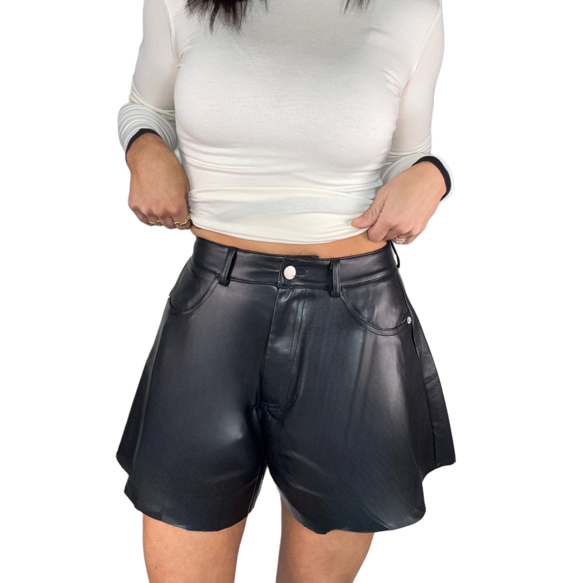 woman wearing black leather shorts on a white background