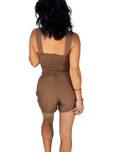 Back profile of a woman wearing a brown satin brown set on a white background