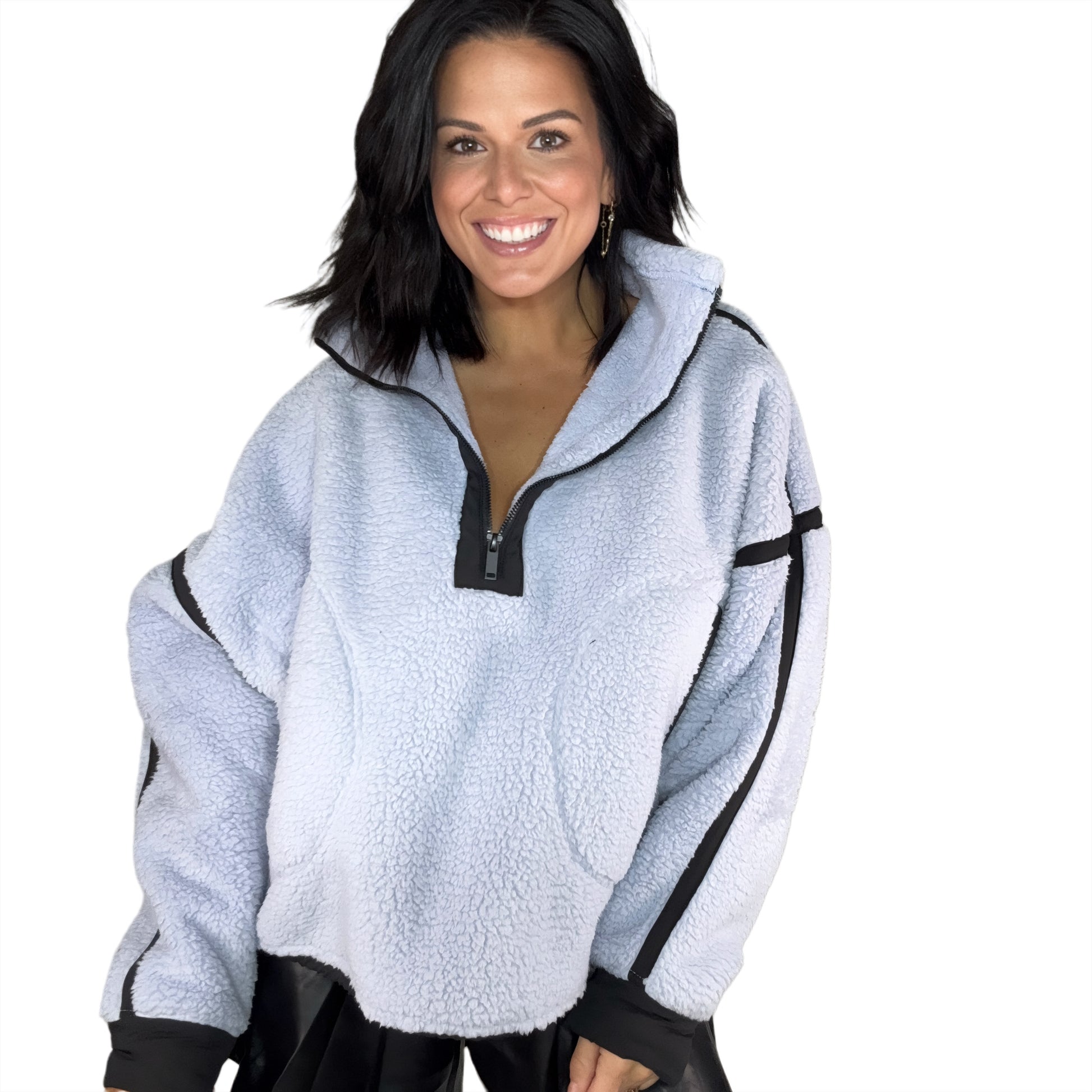 Woman wearing a light blue fleece pullover with black accents on a white background