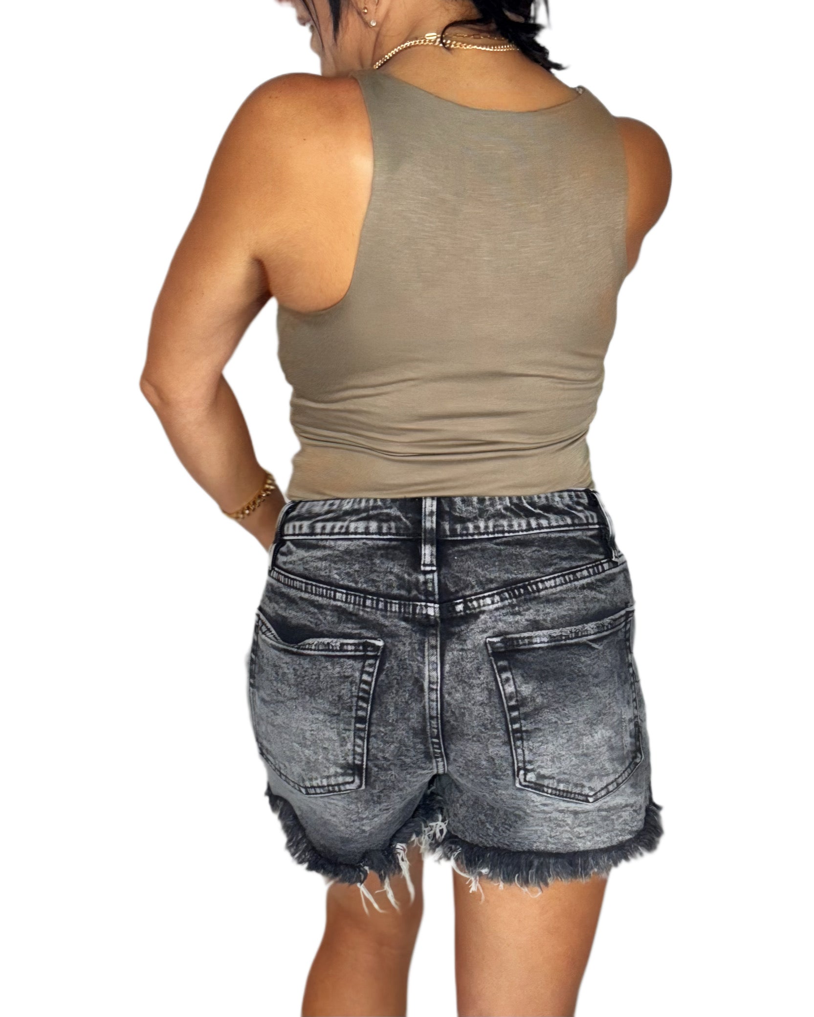 Woman wearing a mocha short sleeve bodysuit and black denim shorts with a white background