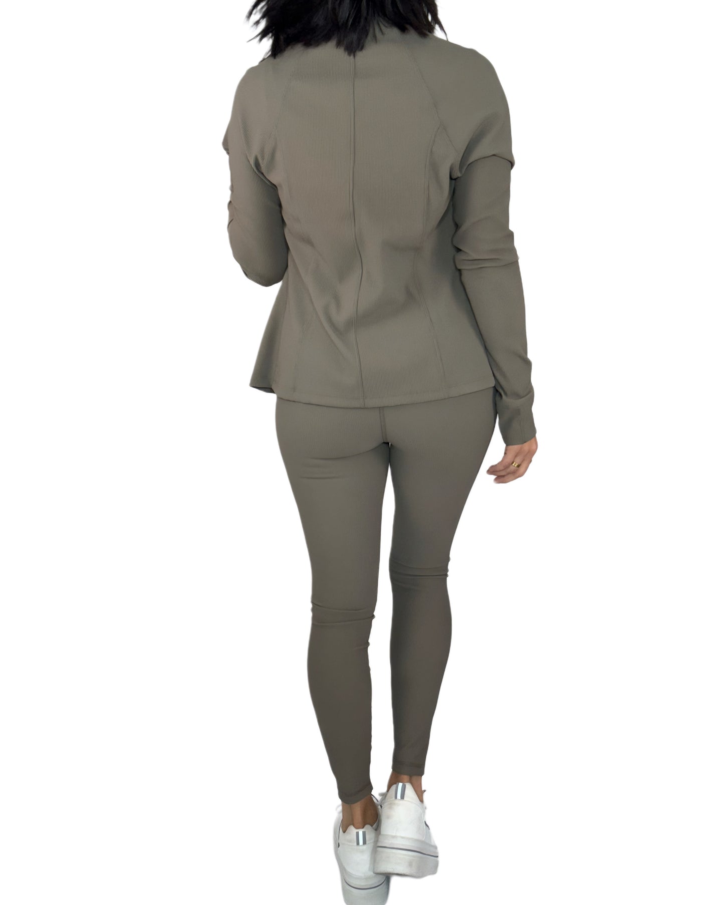 Back view of a woman wearing a green active ribbed set on a white background