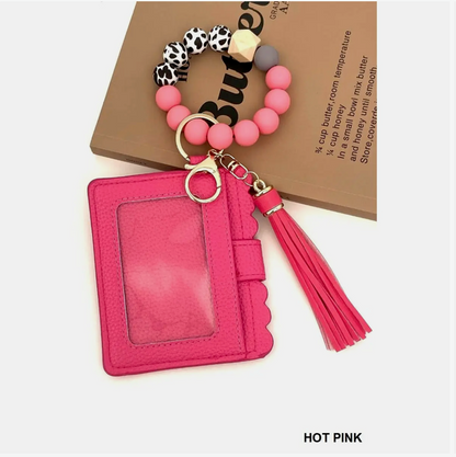 Hot pink cardholder with beaded keychain on a white background